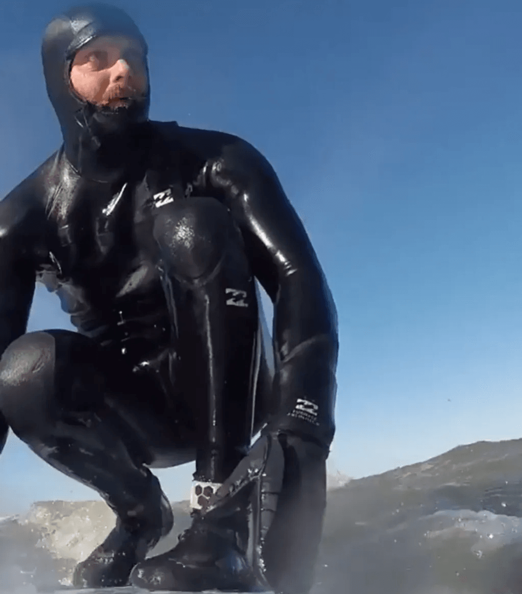 Ash, Strictly Surf instructor, in a wetsuit on the water on Long Island, New York