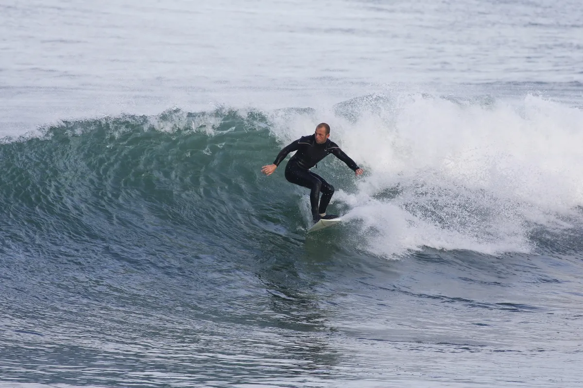 Surfer riding a wave during a private lesson on Long Island's East End